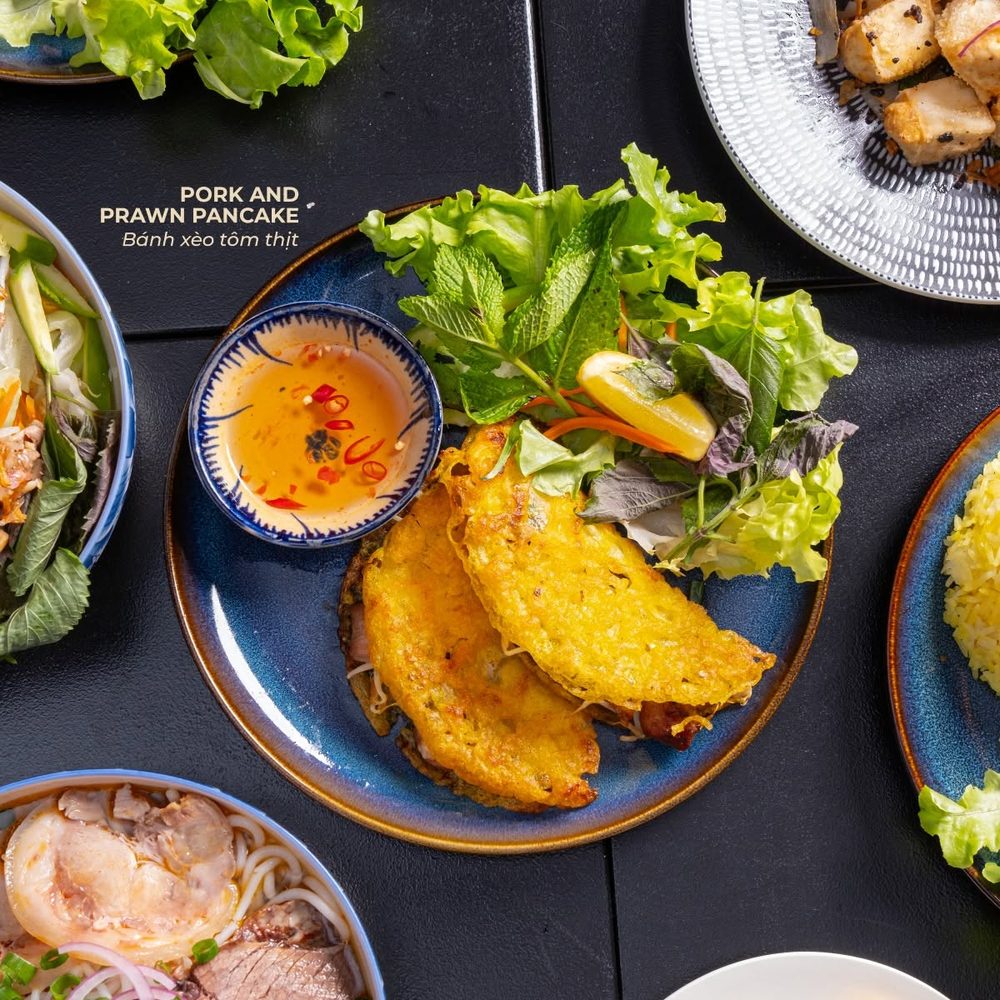Pork and prawn pancake, bánh xèo tôm thịt, served with fresh herbs and dipping sauce